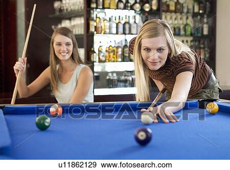 Two teenage girls playing pool View Large Photo Image Stock Photo - Two teenage girls playing pool. Fotosearch
