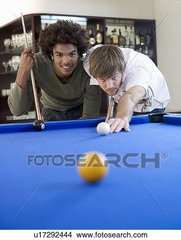 Two young men playing pool View Large Photo Image Picture - Two young men playing pool. Fotosearch