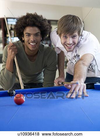 Stock Photo - Two young men playing pool. Fotosearch