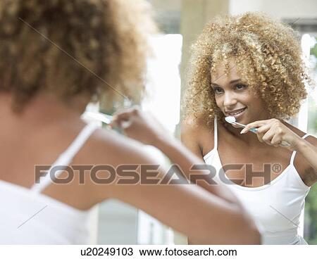 A young woman brushing her teeth View Large Photo Image Stock Image - A young woman brushing her teeth. Fotosearch