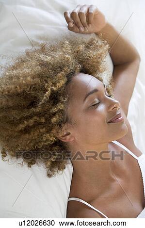 Stock Image - A young woman relaxing. Fotosearch