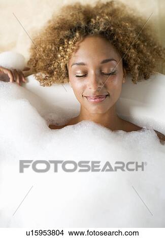 Portrait of a young woman in a bath View Large Photo Image Picture - Portrait of a young woman in a bath. Fotosearch