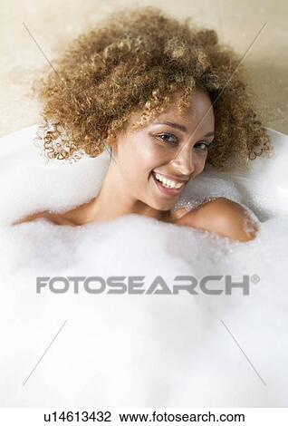 Stock Image - Portrait of a young woman in a bath. Fotosearch