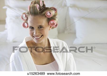 A young woman with her hair in curlers View Large Photo Image Stock Photo - A young woman with her hair in curlers. Fotosearch