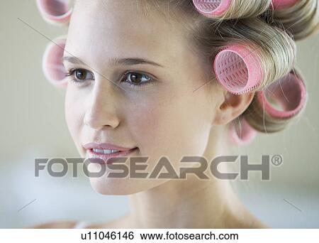 A young woman with her hair in curlers View Large Photo Image Stock Photograph - A young woman with her hair in curlers. Fotosearch
