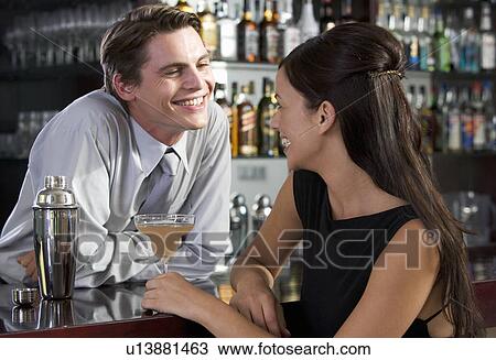 A barman flirting with a customer View Large Photo Image Stock Image - A barman flirting with a customer. Fotosearch