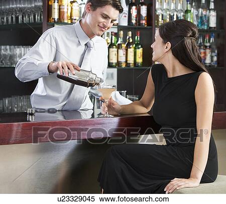 A barman pouring a cocktail for a customer View Large Photo Image Stock Photography - A barman pouring a cocktail for a customer. Fotosearch