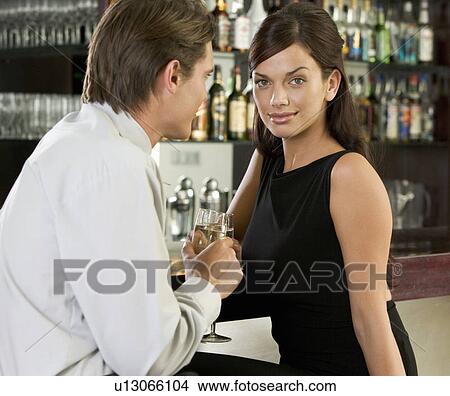 A couple drinking champagne in a bar View Large Photo Image Picture - A couple drinking champagne in a bar. Fotosearch