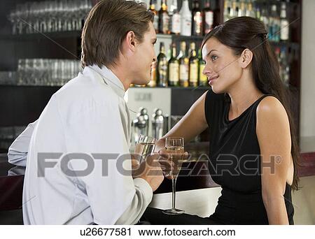 Stock Image - A couple drinking champagne in a bar. Fotosearch