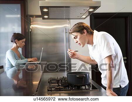 Stock Image - A young couple at home. Fotosearch