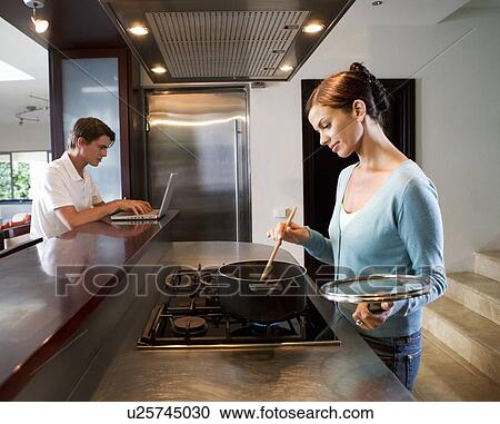A young couple at home View Large Photo Image Stock Image - A young couple at home. Fotosearch