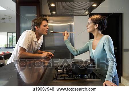 A young couple at home View Large Photo Image Stock Photo - A young couple at home. Fotosearch