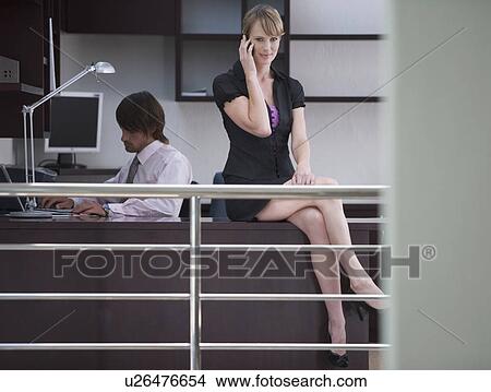 A businessman and woman in the office View Large Photo Image Picture - A businessman and woman in the office. Fotosearch
