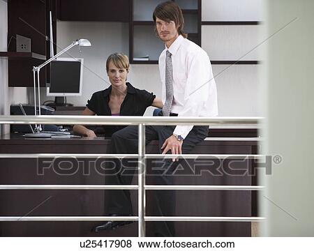 A businessman and woman in the office View Large Photo Image Stock Photo - A businessman and woman in the office. Fotosearch
