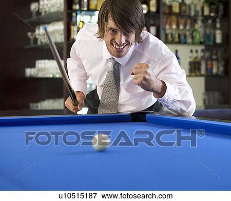 A businessman playing pool in a bar View Large Photo Image Stock Photo - A businessman playing pool in a bar. Fotosearch