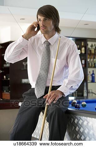A businessman playing pool in a bar View Large Photo Image Stock Photo - A businessman playing pool in a bar. Fotosearch