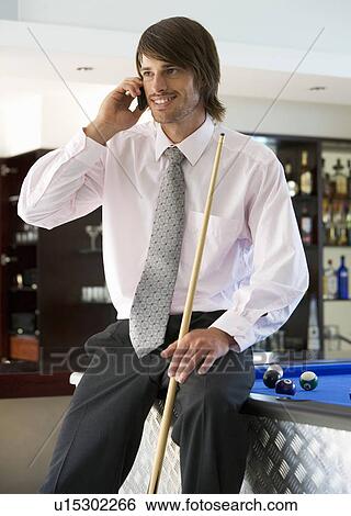 A businessman playing pool in a bar View Large Photo Image Stock Photograph - A businessman playing pool in a bar. Fotosearch