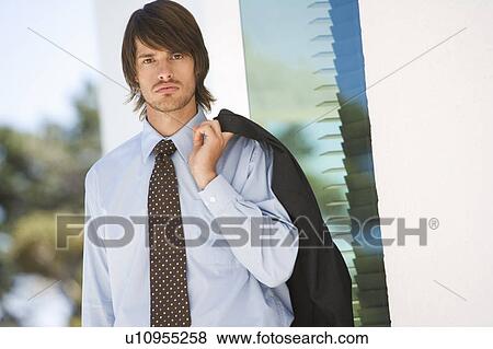 A businessman standing outside View Large Photo Image Stock Photo - A businessman standing outside. Fotosearch