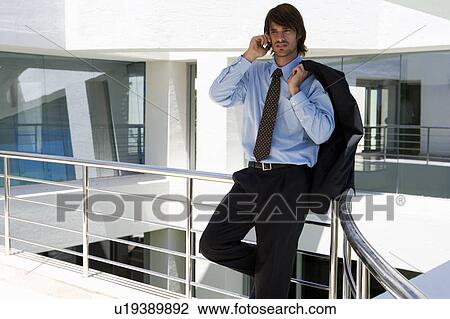 A businessman using a mobile phone View Large Photo Image Stock Image - A businessman using a mobile phone. Fotosearch
