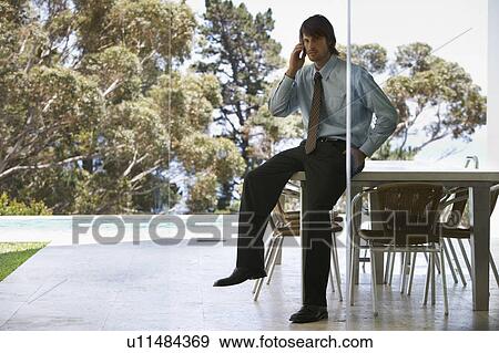 A businessman using a mobile phone View Large Photo Image Stock Photo - A businessman using a mobile phone. Fotosearch