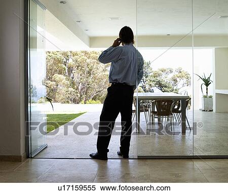 Stock Photography - A businessman using a mobile phone. Fotosearch