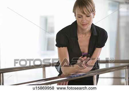 Stock Photo - A businesswoman reading a text message. Fotosearch