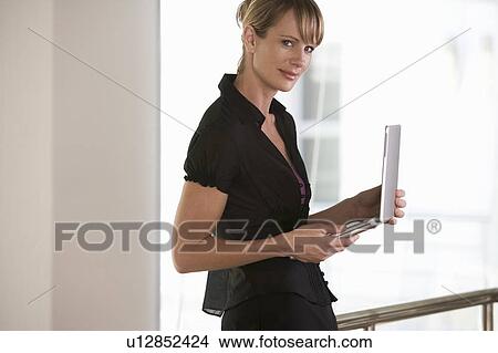 Picture - A businesswoman using a laptop. Fotosearch