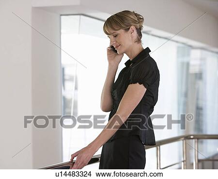 A businesswoman using a mobile phone View Large Photo Image Picture - A businesswoman using a mobile phone. Fotosearch