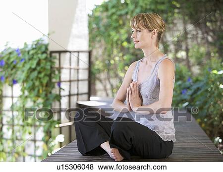 Stock Photo - A young woman meditating. Fotosearch