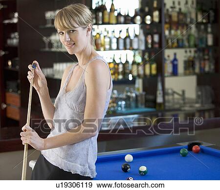 A young woman playing pool View Large Photo Image Stock Photo - A young woman playing pool. Fotosearch