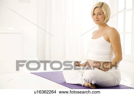 A pregnant woman practicing yoga View Large Photo Image Picture - A pregnant woman practicing yoga. Fotosearch