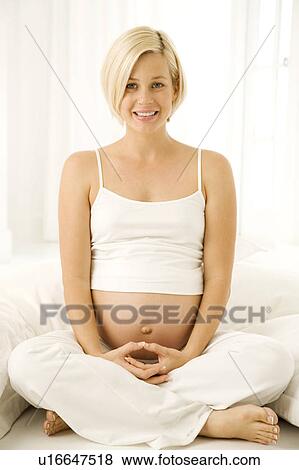 A pregnant woman practicing yoga View Large Photo Image Stock Photo - A pregnant woman practicing yoga. Fotosearch