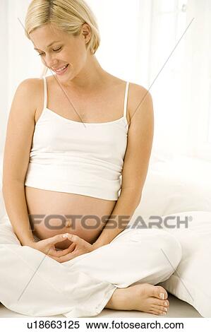 A pregnant woman practicing yoga View Large Photo Image Stock Photography - A pregnant woman practicing yoga. Fotosearch