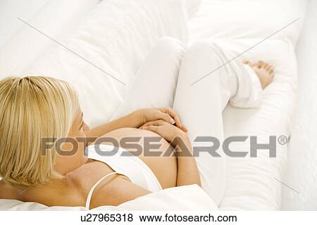 A pregnant woman relaxing View Large Photo Image Stock Photo - A pregnant woman relaxing. Fotosearch