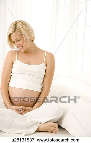 A pregnant woman relaxing View Large Photo Image Stock Photo - A pregnant woman relaxing. Fotosearch