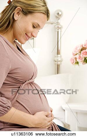 A pregnant woman relaxing View Large Photo Image Stock Photograph - A pregnant woman relaxing. Fotosearch