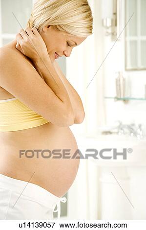 A pregnant woman weighing herself View Large Photo Image Stock Photo - A pregnant woman weighing herself. Fotosearch