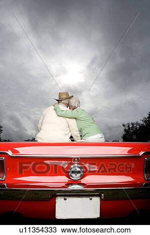 Stock Image - A senior couple in a sports car. Fotosearch