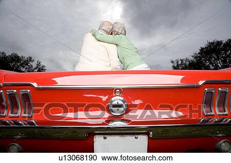 Stock Image - A senior couple in a sports car. Fotosearch