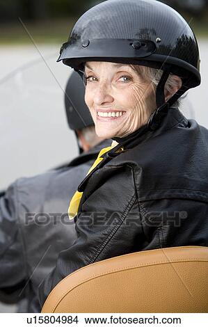 Picture - A senior couple on a motorbike. Fotosearch