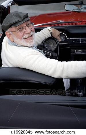 Stock Photography - A senior man driving a sports car. Fotosearch