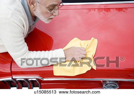 A senior man polishing a sports car View Large Photo Image Stock Image - A senior man polishing a sports car. Fotosearch