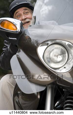 A senior man riding a motorbike View Large Photo Image Picture - A senior man riding a motorbike. Fotosearch