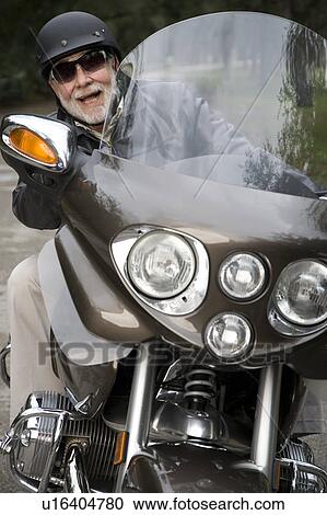 A senior man riding a motorbike View Large Photo Image Stock Image - A senior man riding a motorbike. Fotosearch