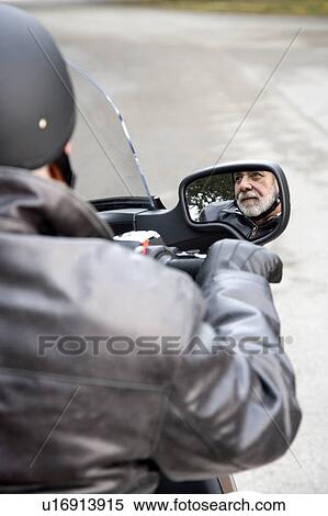 A senior man riding a motorbike View Large Photo Image Stock Photography - A senior man riding a motorbike. Fotosearch