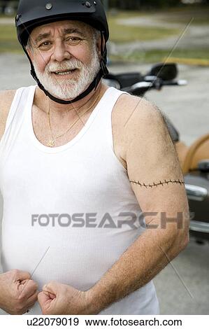 A senior man wearing a helmet View Large Photo Image Stock Photo - A senior man wearing a helmet. Fotosearch