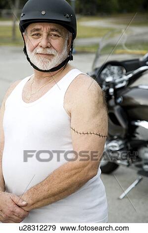 A senior man wearing a helmet View Large Photo Image Stock Photo - A senior man wearing a helmet. Fotosearch