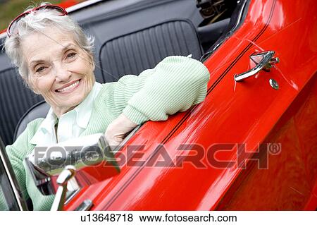 A senior woman driving a sports car View Large Photo Image Stock Photo - A senior woman driving a sports car. Fotosearch