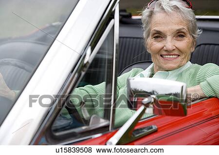 A senior woman driving a sports car View Large Photo Image Stock Photo - A senior woman driving a sports car. Fotosearch