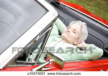 A senior woman sitting in a sports car View Large Photo Image Stock Image - A senior woman sitting in a sports car. Fotosearch